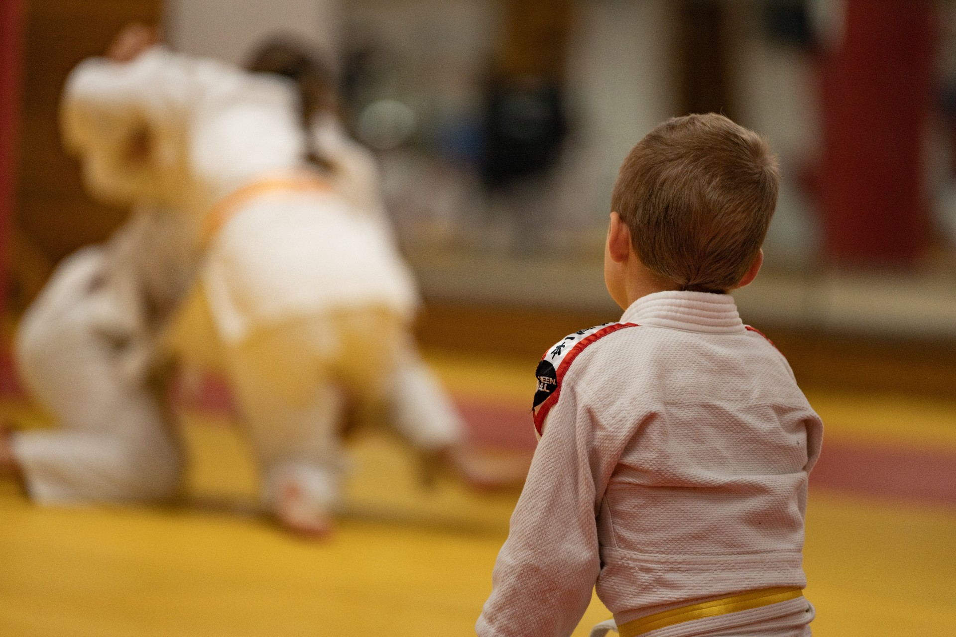 child sitting watching karate training