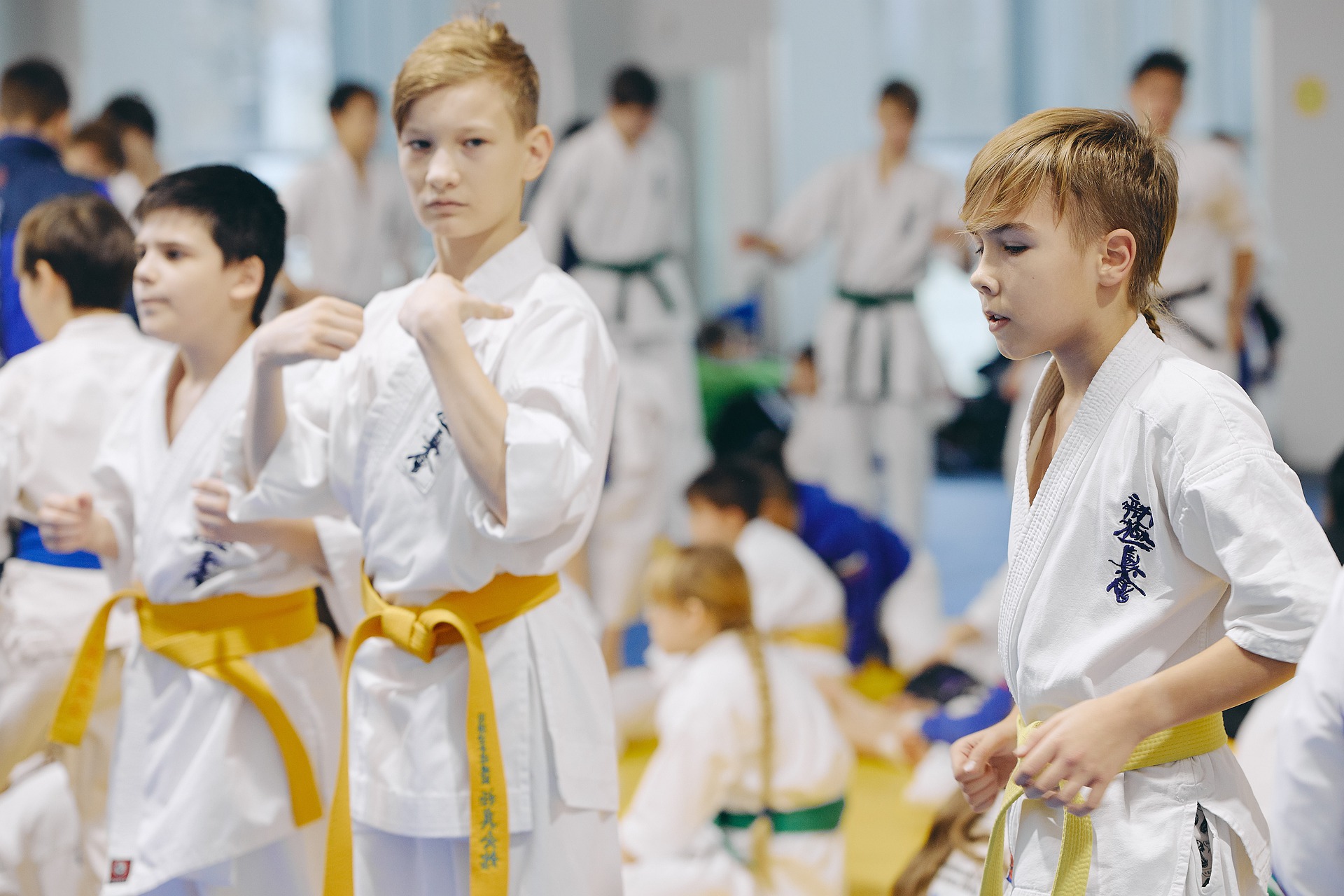 three yellow belt boys standing