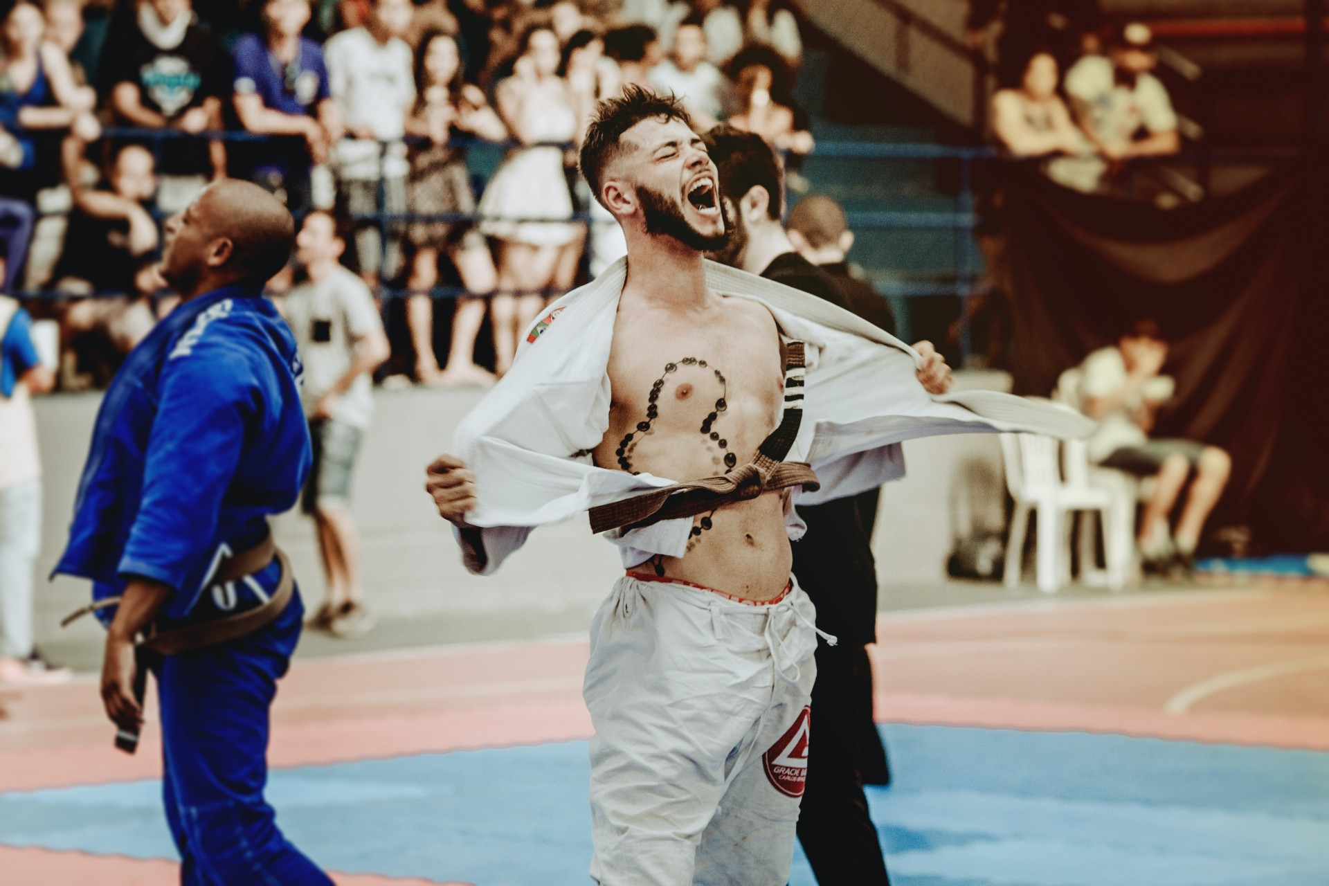 man celebrating by ripping his gi off